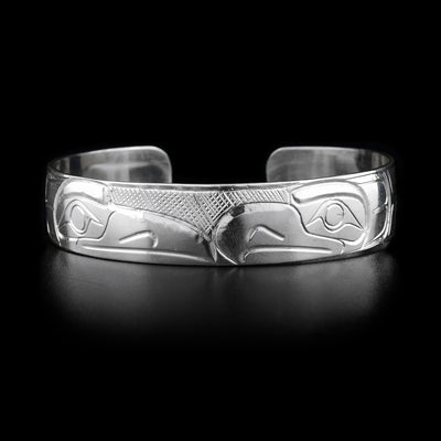 This sterling silver cuff bracelet has depictions of the Raven and the Eagle carved into it. Thier heads meet at the top of the bracelet.