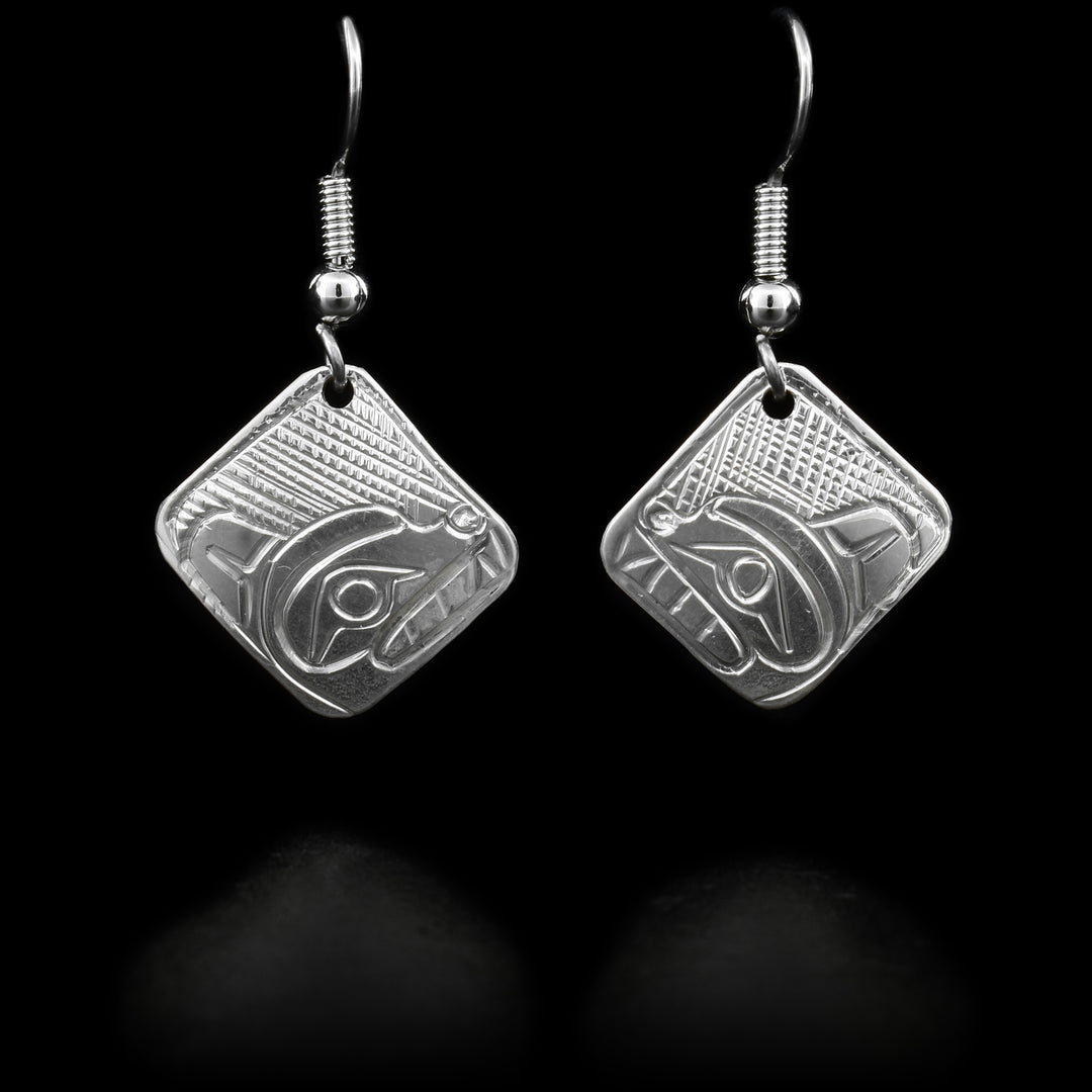 These dangling Bear earrings are made using sterling silver and have square, diamond shaped hangs. There are depictions of the Bear caved into the surface of the hangs.