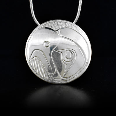 This sterling silver pendant is circle shaped and has the Eagle carved into it.
