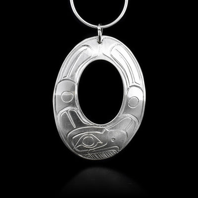 This sterling silver pendant is oval shaped with a large oval cutout in the middle. Engraved into the pendant is the Eagle. 