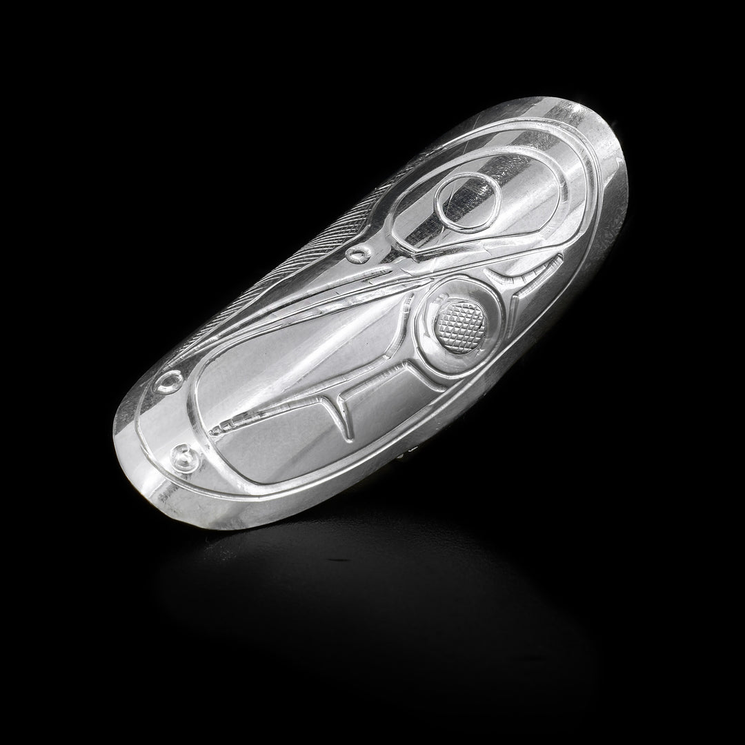 This sterling silver Hummingbird ring has a large oval shield that extends along the finger. Carved into the shield is a depiction of the Hummingbird.