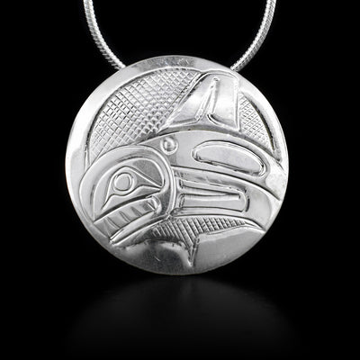 This sterling silver pendant is circle shaped and has the Orca craved into its surface.