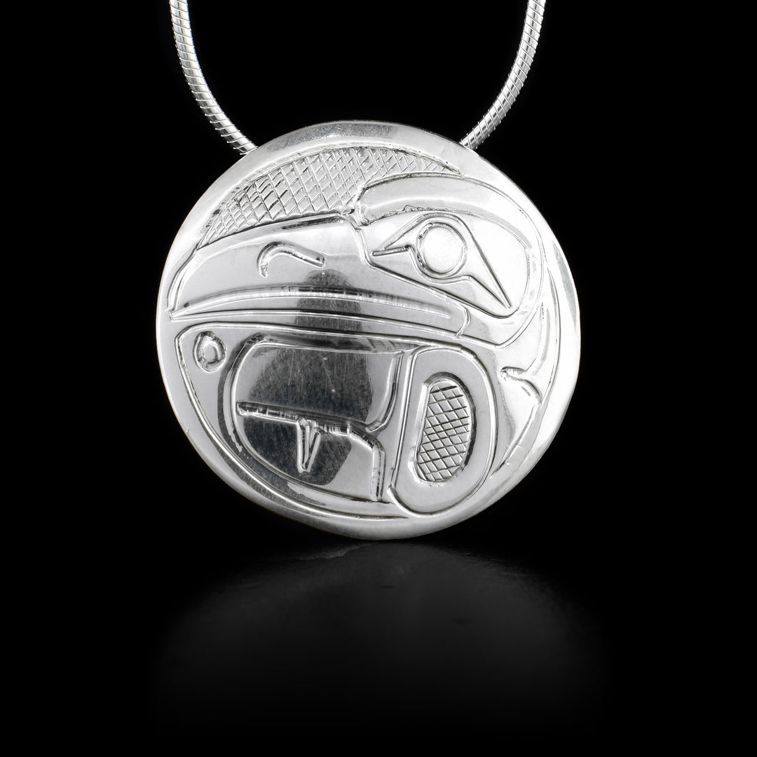 This Raven pendant is made from sterling silver and has a circle shape to it. There is a gorgeous depiction of the Raven that has been carved into the surface of the pendant.