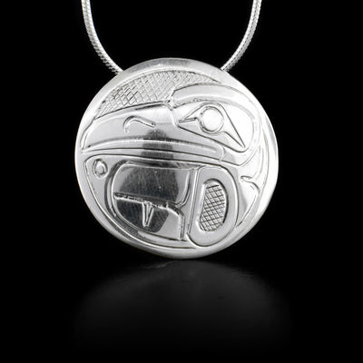 This sterling silver pendant is circle shaped and has the Raven carved into its surface.