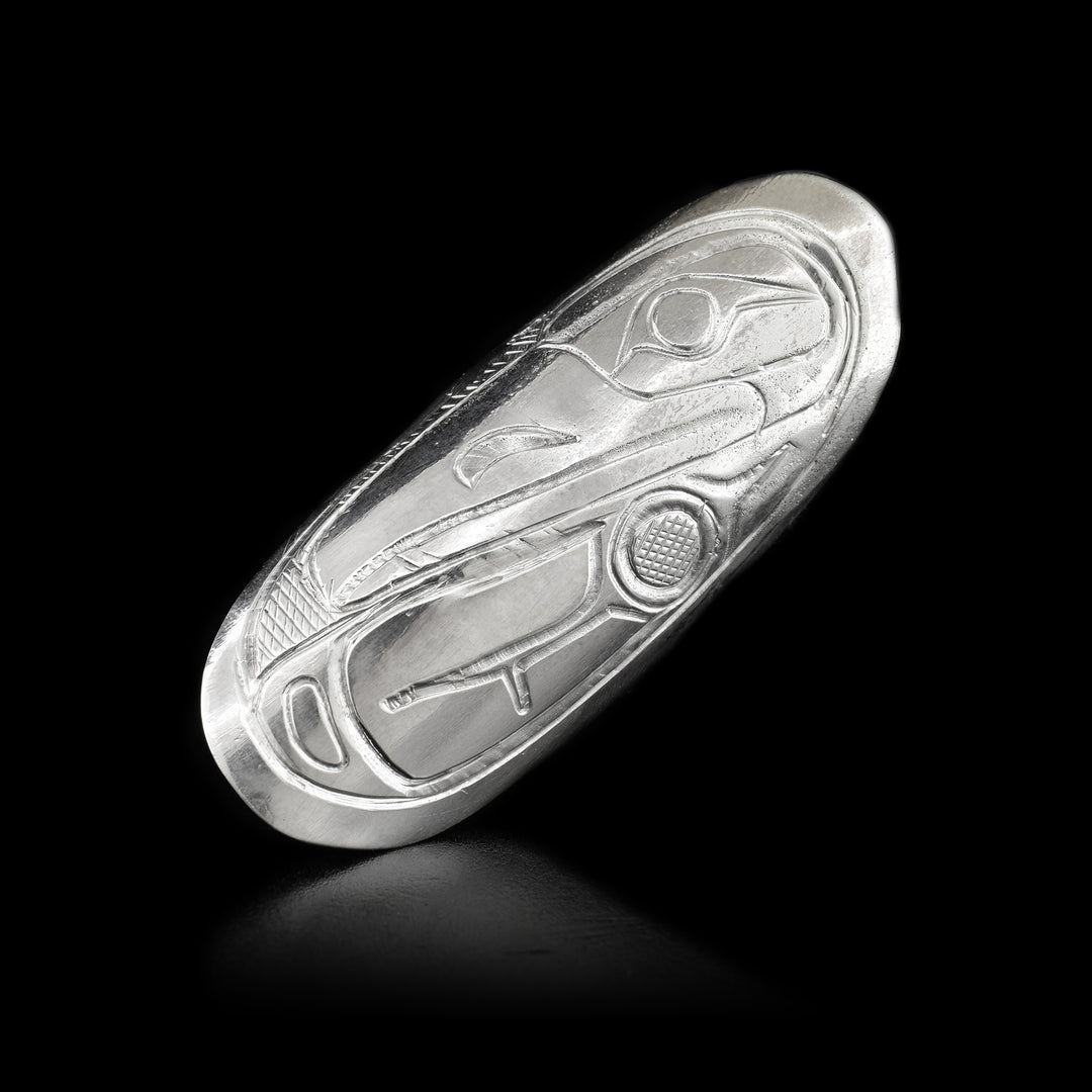 This sterling silver ring has an oval shield that extends along the finger. the Raven is carved into the shield.