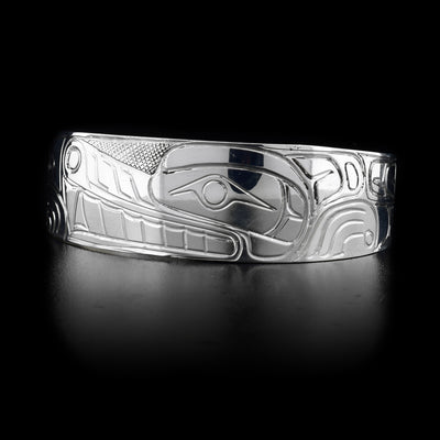 This sterling silver cuff bracelet is wide and has thick carvings that depict the Wolf on its surface.