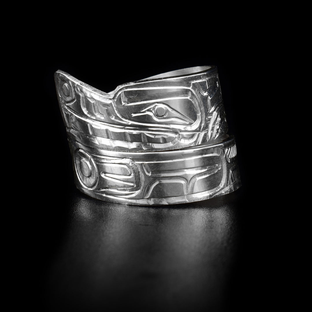This sterling silver wolf ring has carvings that depict the Wolf on it and its tapered band wraps around the finger twice.