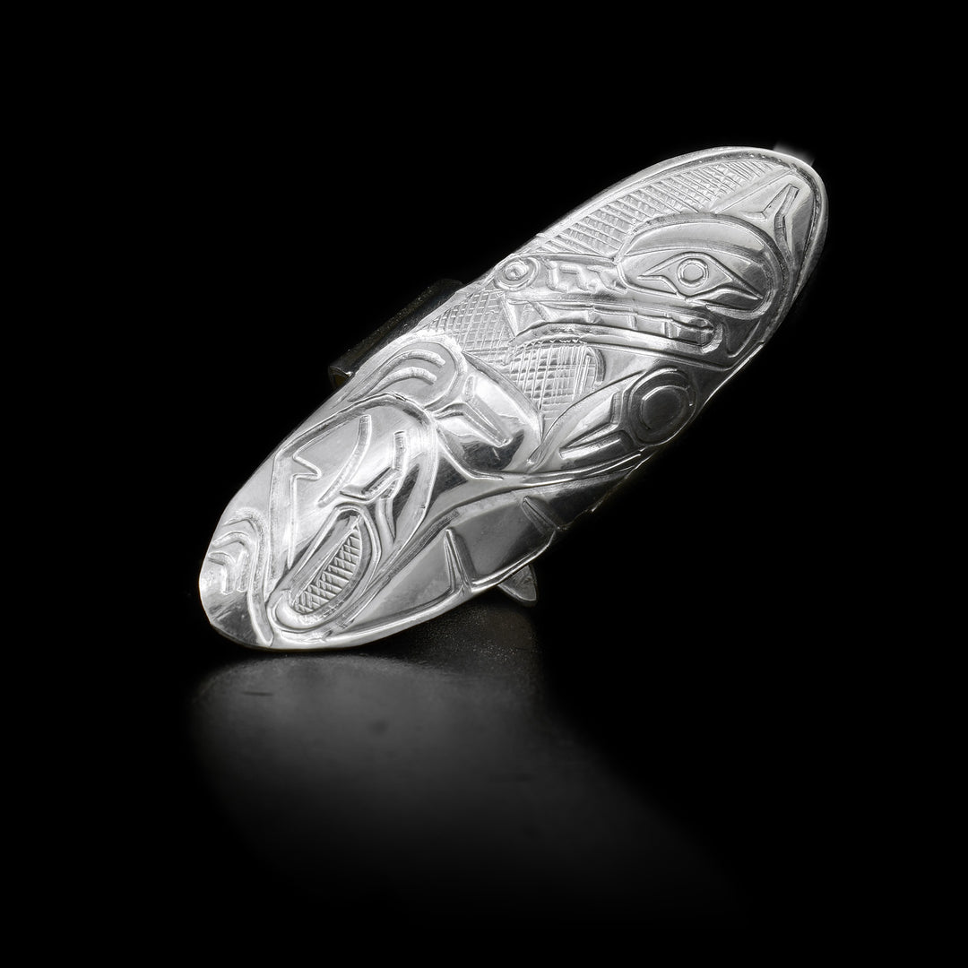 This sterling silver Wolf ring has a large oval shield that extends along the finger. Carved into the shield is a depiction of the Wolf.