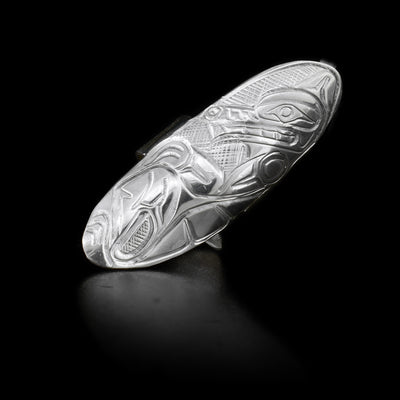 This sterling silver ring has a large oval shield that extends along the finger. Carved into the shield is a depiction of the Wolf.