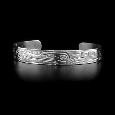 This sterling silver cuff bracelet is thin and has a depiction of the Wolf carved into it. 