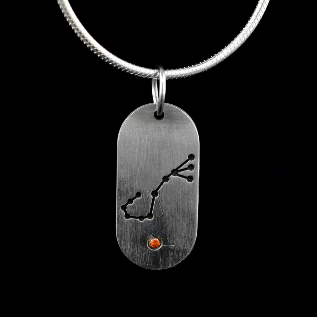 This November Zodiac Pendant features the November constellation of the Scorpio. Underneath is a orange cubic zirconia.