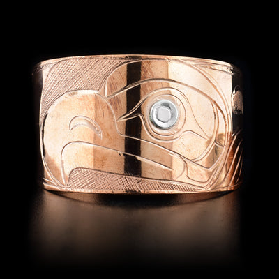 Front of bracelet featuring eagle head with sterling silver in eye. Cross-hatching background. Hand-carved by Kwakwaka’wakw artist Norman Seaweed.
