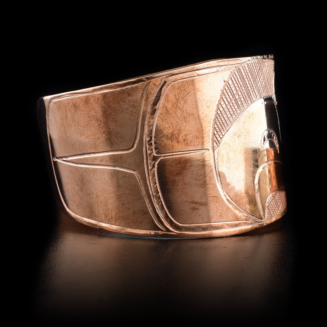 Right side features a carved feather-like design.