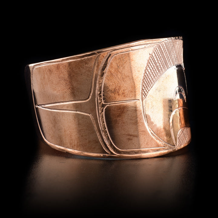 Right side features a carved feather-like design.