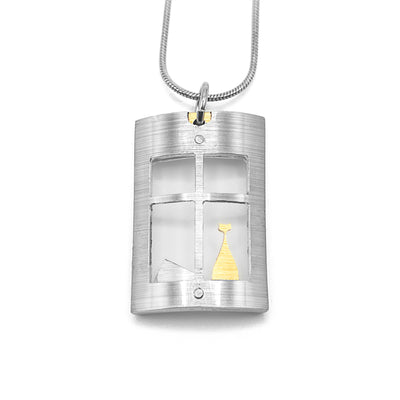 Curved, rectangular brushed and anodized aluminum pendant. Pendant is a silver-colour window with gold-colour cat looking out. Silver-colour hill in window as well. Minimalist design. By JR Franco. Stainless steel snake chain included.