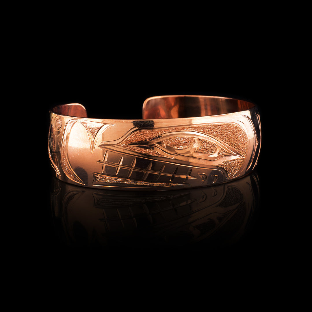 this 3/4" wide copper cuf has the engraving of the Orca through the whole bracelet.