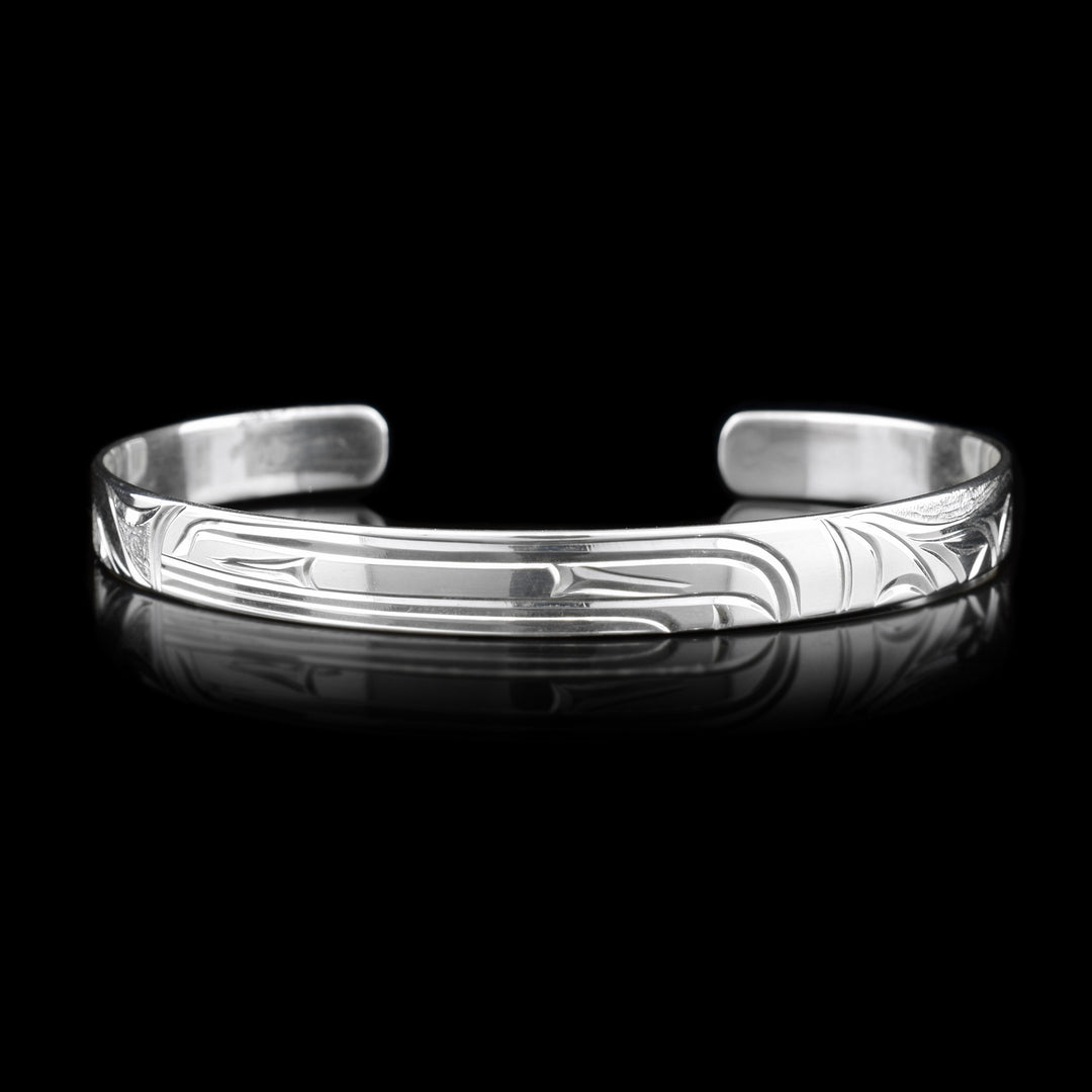 This silver cuff bracelet depicts the head of an Orca in the center facing the left.