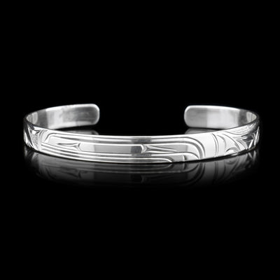 This silver cuff bracelet depicts the head of an Orca in the center facing the left.