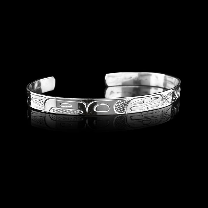 Orca and Salmon Cuff Bracelet  - Made with sterling silver the legend of the  Orca and Salmon is carved onto this cuff bracelet sold at Artina's.