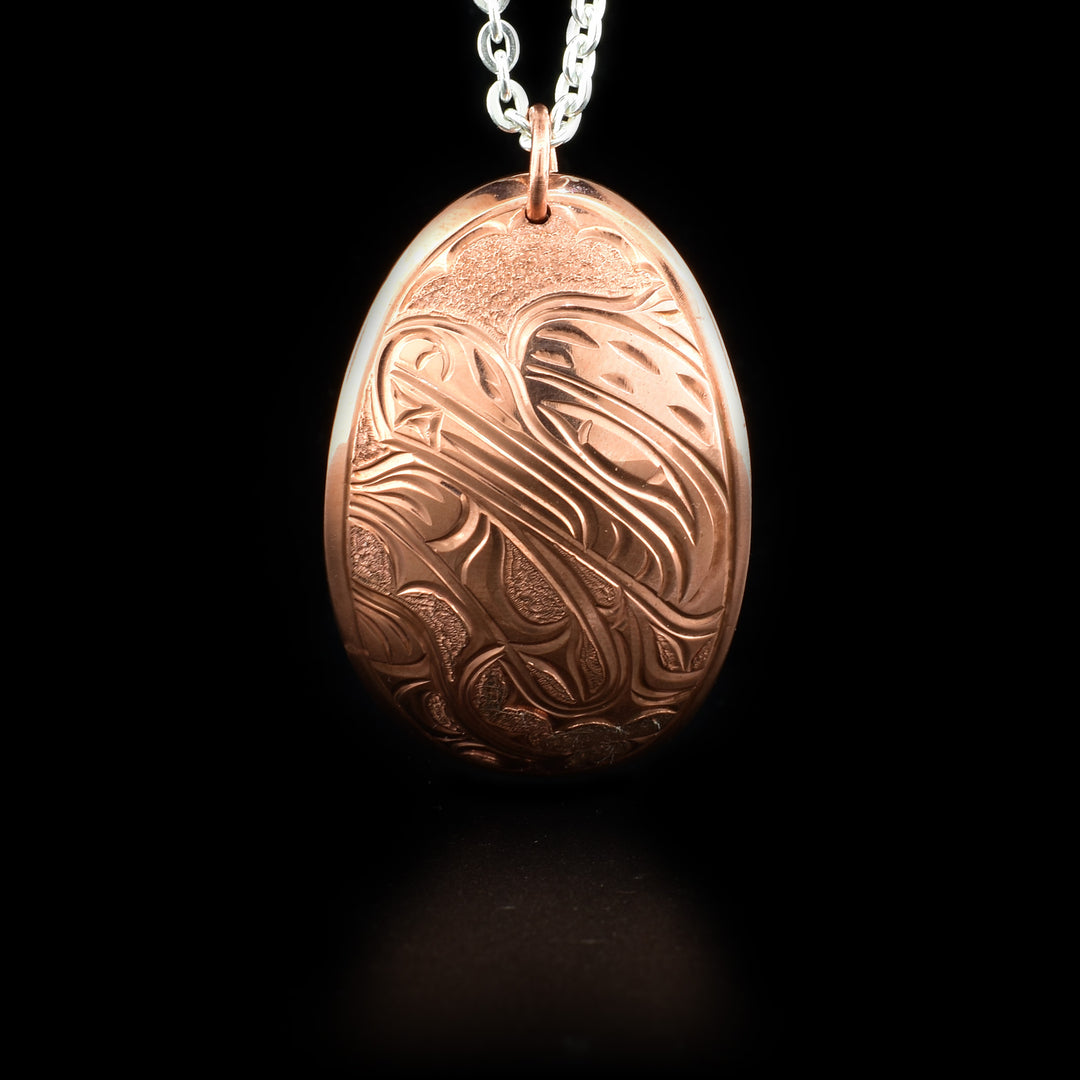 Curved oval pendant with bear hand-carved by Kwakwaka’wakw artist Cristiano Bruno.