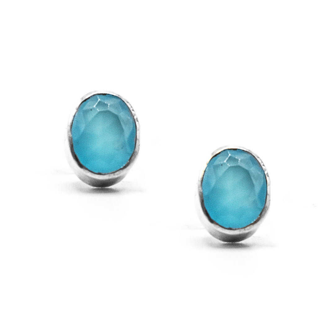 Vertical oval blue topaz set in sterling silver. 0.45” x 0.25”. By Elizabeth Burry.