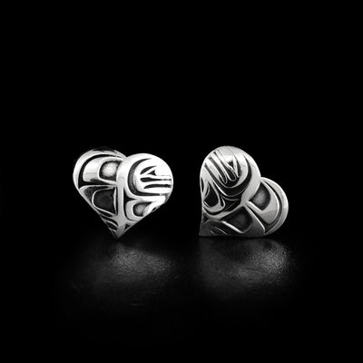 Oxidized sterling silver heart-shaped stud earrings. Each earring depicts an orca. By Tahltan artist Grant Pauls.
