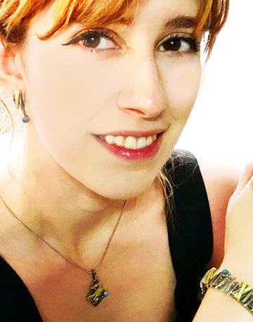 A model is shown wearing the pendant and her face is in the photo.