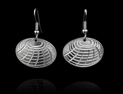 These sterling silver dangle earrings are shaped like and have carvings on the surface of them that depict clams.