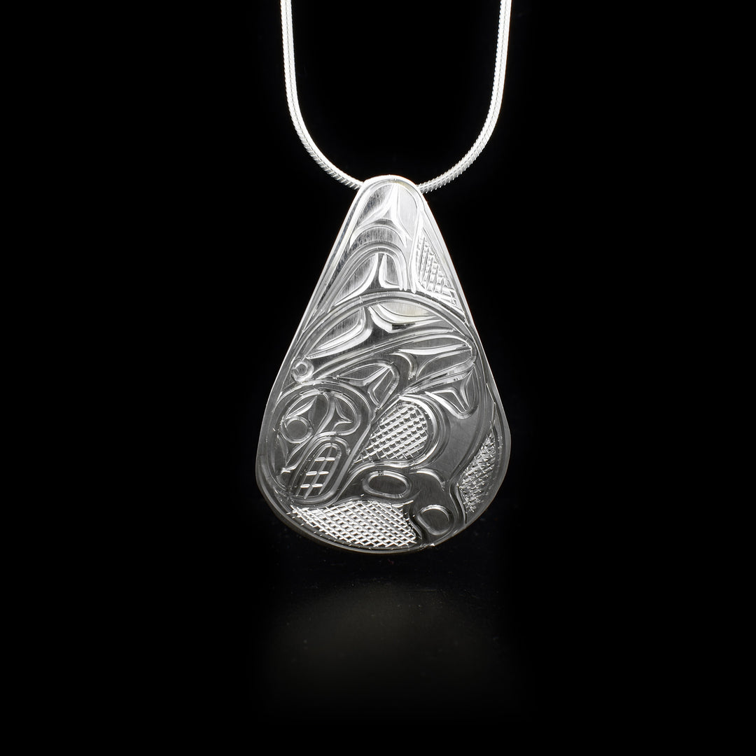 This sterling silver pendant is tear drop shaped and has the Orca carved into it.