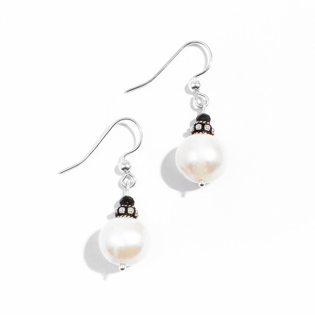 Sterling silver white freshwater pearl and black crystal dangle earrings.