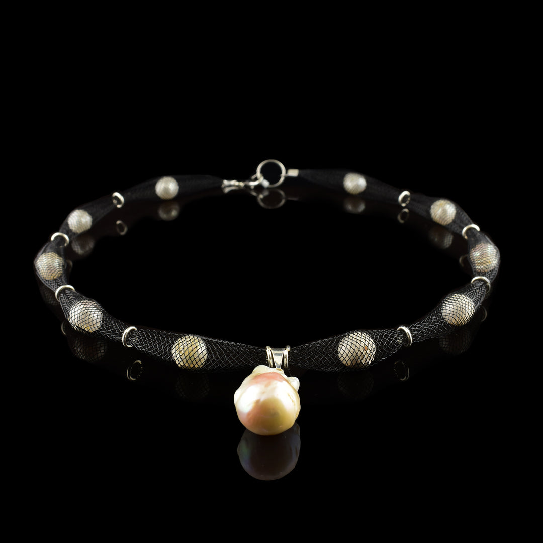 Shop our handcrafted netted necklace featuring a striking baroque pearl pendant. A unique, contemporary design by our in-house jewelry artist. Fast shipping!