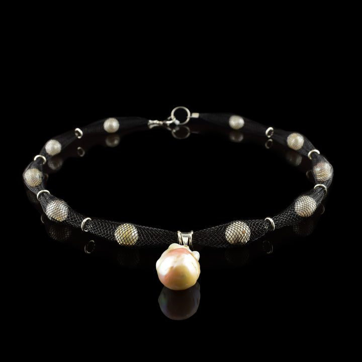 Shop our handcrafted netted necklace featuring a striking baroque pearl pendant. A unique, contemporary design by our in-house jewelry artist. Fast shipping!