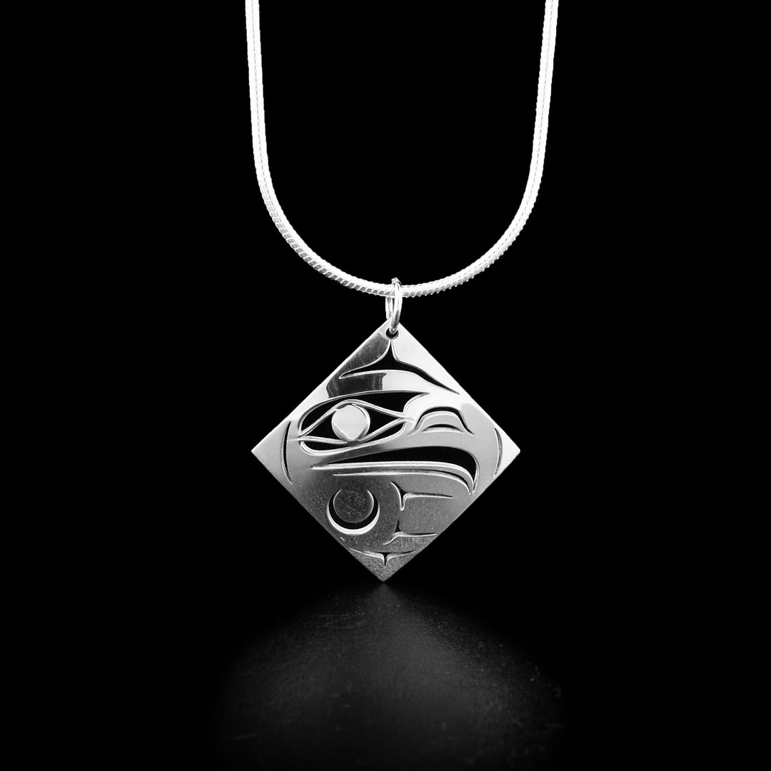 This Eagle pendant is made from sterling silver and is shaped like a diamond. There is a cutout depiction of the Eagle in the pendant.