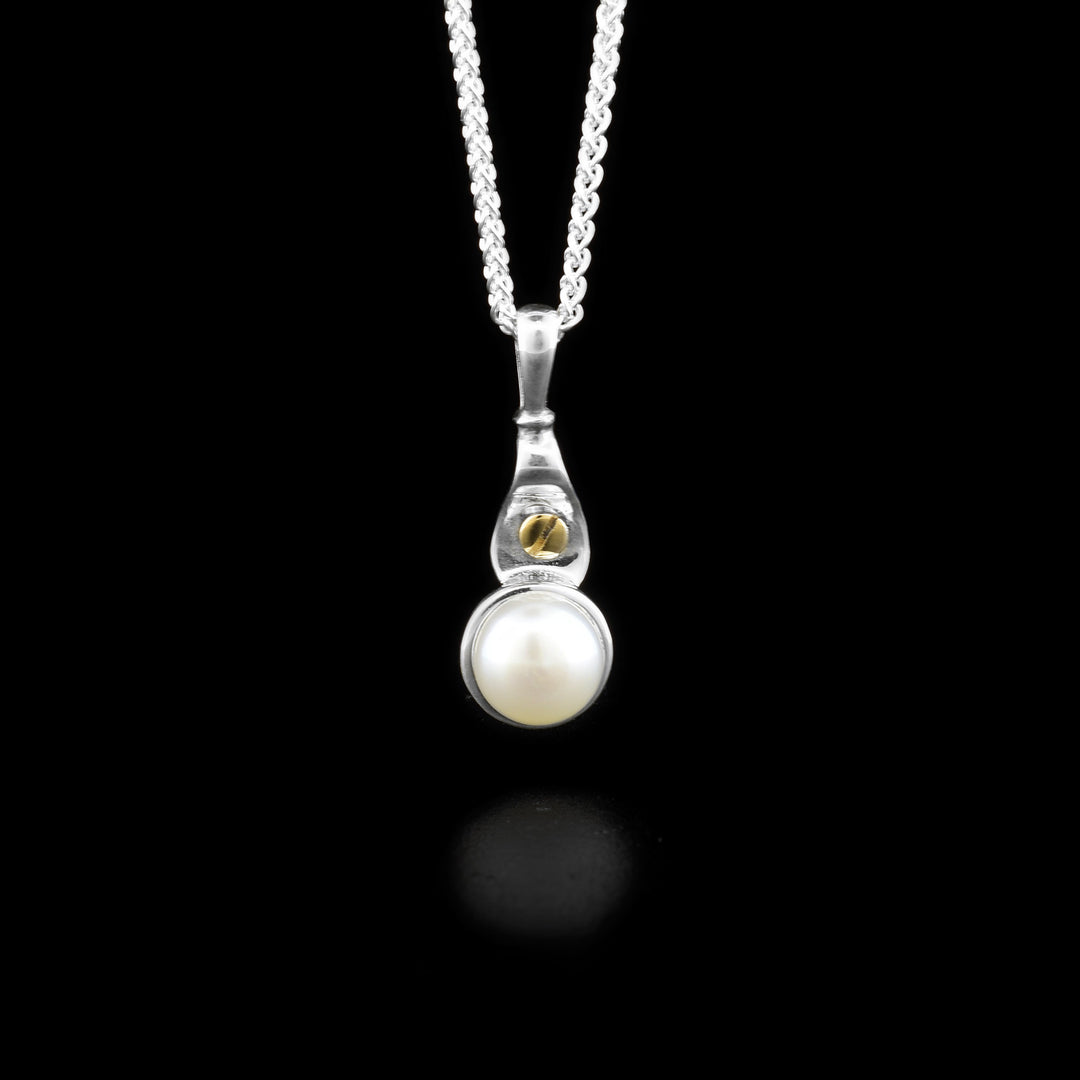 Sterling silver pendant with white freshwater mabe pearl and dainty 14K yellow gold bolt adornment above.