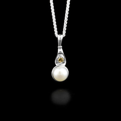 Sterling silver pendant with white freshwater mabe pearl and dainty 14K yellow gold bolt adornment above.