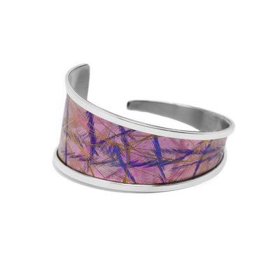 Anodized pink titanium is framed by sterling silver. Bracelet is tapered, starts out wide on the back right end at 1.25” and tapers down to 0.15” on the left back end.