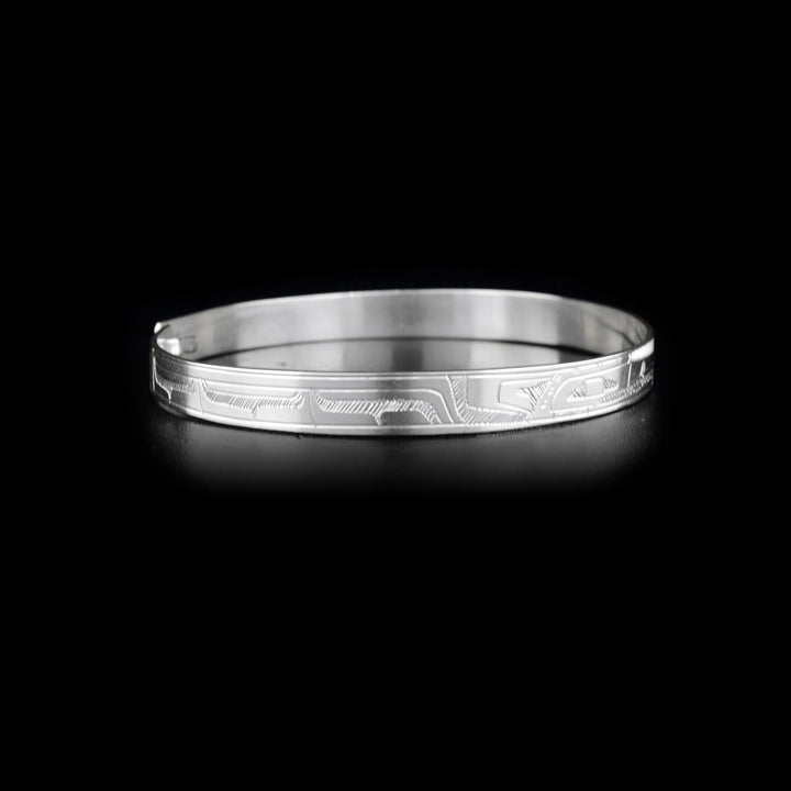 Right side of bracelet with carved designs that resemble a wing.