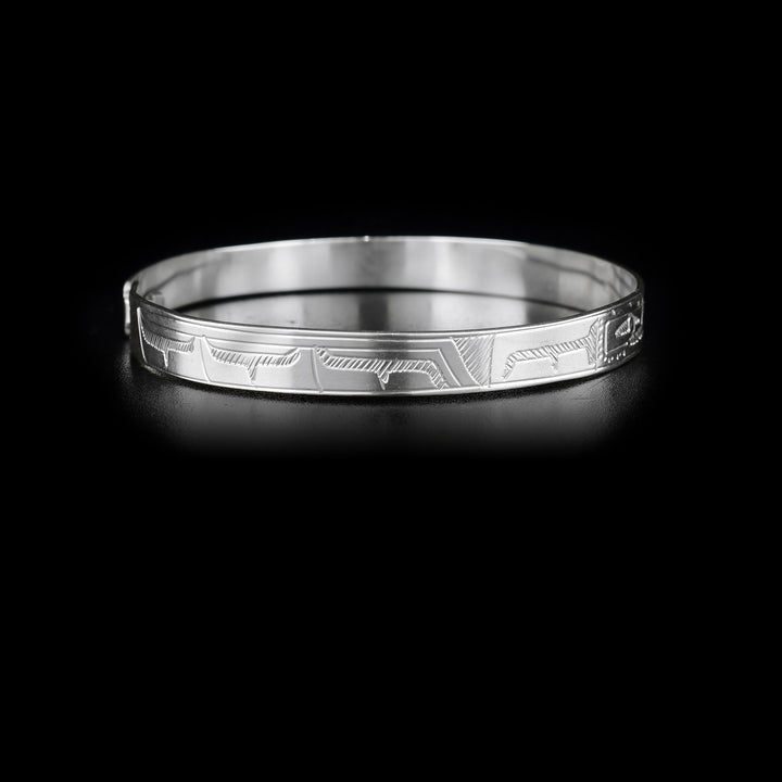 Right side of bracelet with carved designs that resemble a wing.