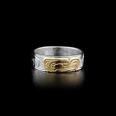 Sterling silver ring with 14K yellow gold eagle head facing left. Carved background designs. 0.25” band width. By Kwakwaka’wakw artist Victoria Harper.