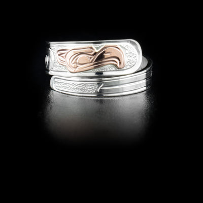 Sterling silver wrap ring with 14K rose gold eagle head. Band is 0.25” at its widest. Hand-carved by Kwakwaka’wakw artist Victoria Harper.