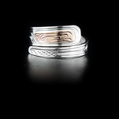 Sterling silver wrap ring with 14K rose gold raven head. Band is 0.25” at its widest. Hand-carved by Kwakwaka’wakw artist Victoria Harper.