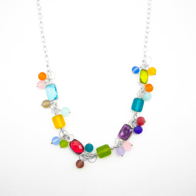 Sterling silver chain necklace with cluster of matte glass beads of various colours. Four featured rectangular, faceted stones are peridot, amethyst, ruby quartz and blue topaz.