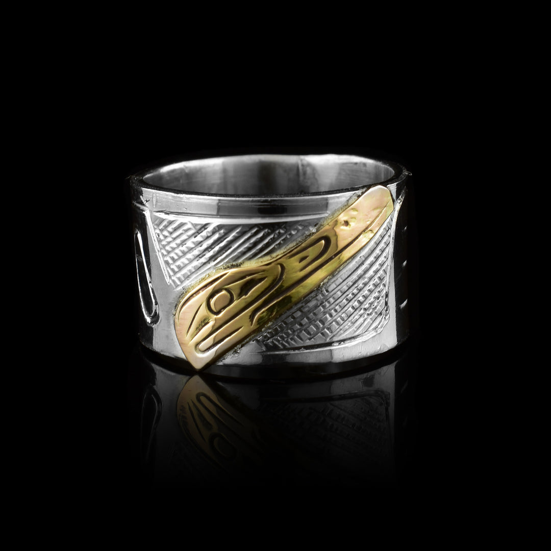 this sterling silver and 10k gold band by artist Graham Henry. Featuring the Raven legend hand-carved in solid gold against a carved silver band.