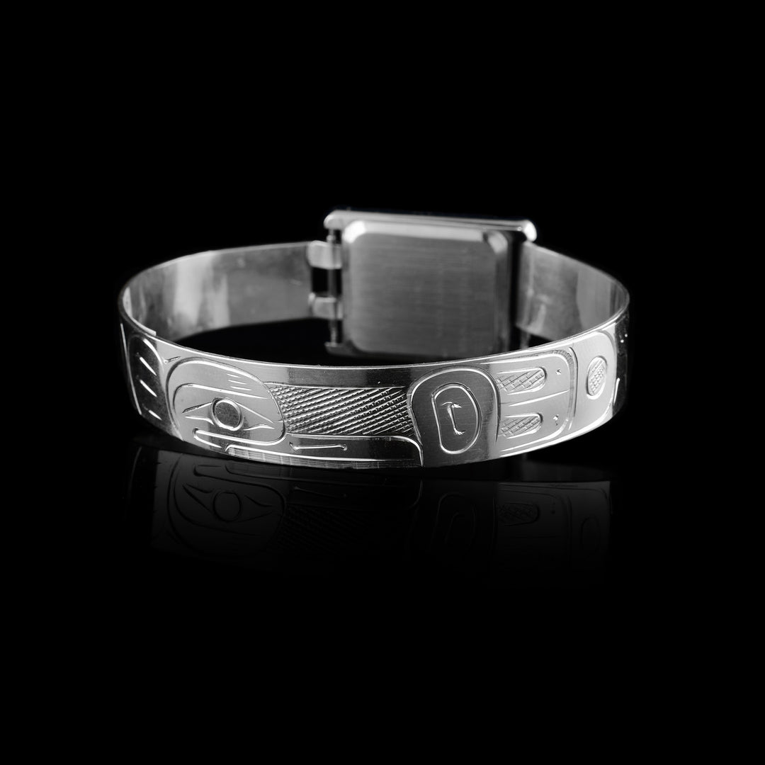 Made from sterling silver the Raven legend wraps around the band of the watch. With a rectangular clock face a top of it.