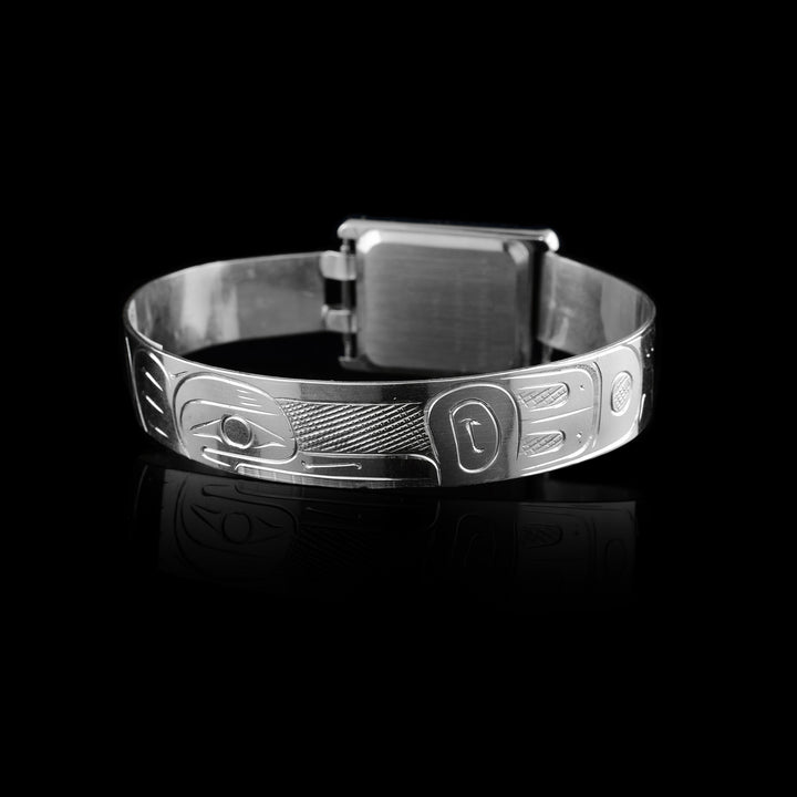 Made from sterling silver the Raven legend wraps around the band of the watch. With a rectangular clock face a top of it.