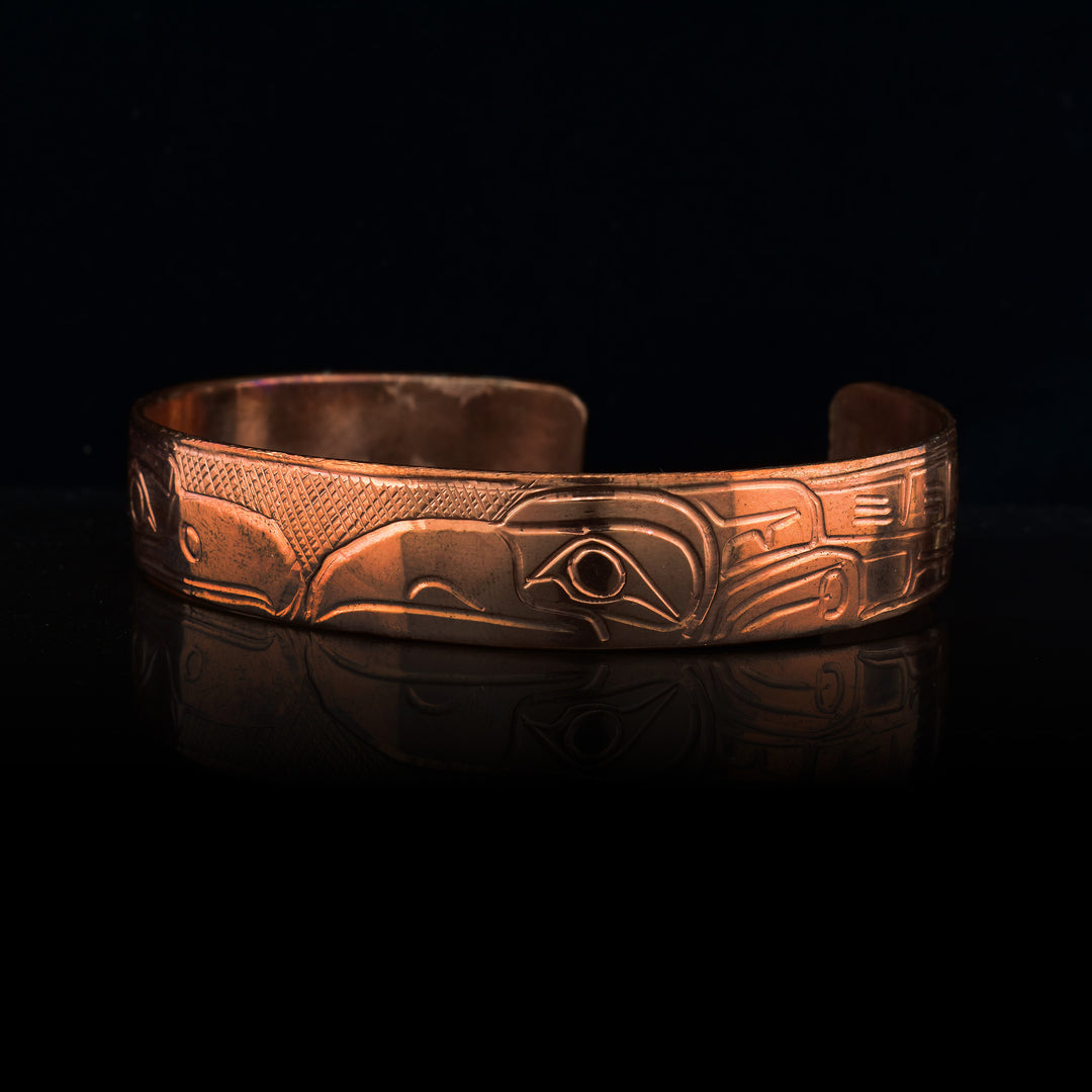Raven and Eagle Copper Cuff, the eagle and raven face each other on the cuff the rest of their bodies carved along the cuff to the back.