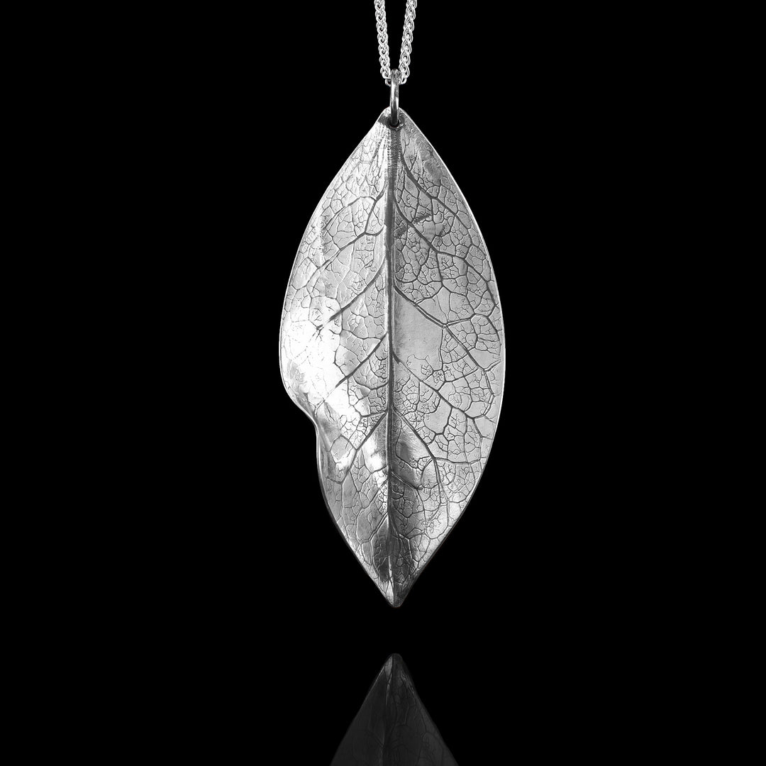 Realistic Silver Leaf Necklace is made out of sterling silver and is shaped and textured to look like a real leaf.