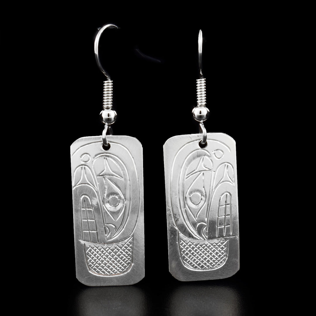 These dangling Orca earrings are made from sterling silver and the hangs are large and rectangular. There are depictions of the Orca carved into the surface of the hangs.