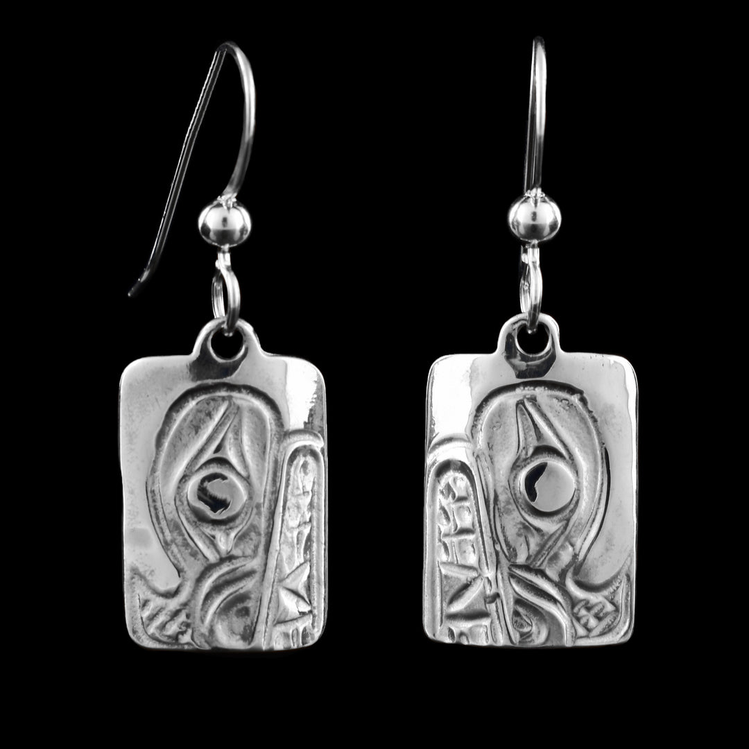 These Silver Bear Earrings are rectangular pendant fish hook earrings are engraved with the bear, the bear's eye is the central focus, a classic element of earring, surrounded by bold lines and symbolic patterns that suggest strength, protection. 