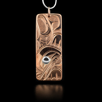 Rectangular copper pendant with abstract frog design. Sterling silver in eye. Hand-carved by Kwakwaka’wakw artist Cristiano Bruno.